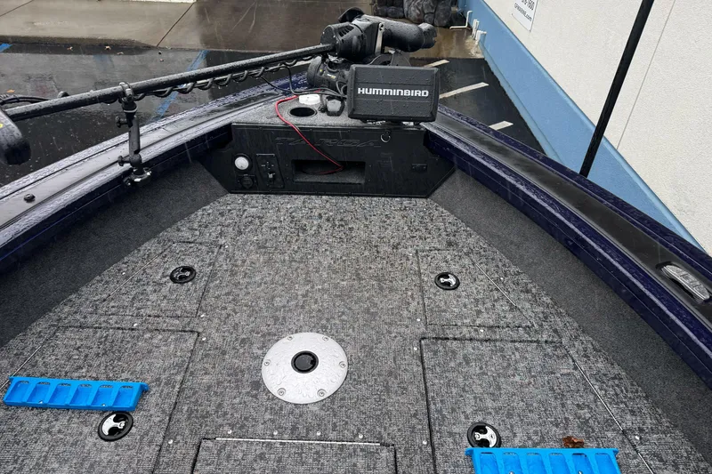 Slide: The Image of 2025 Tracker Targa V-19 WT boat deck with Humminbird equipment, wet from rain. - 11