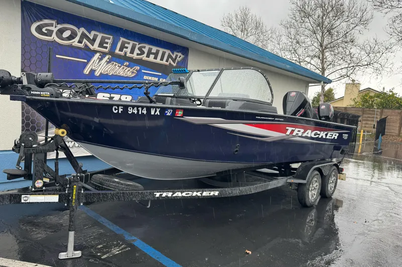 Slide: The Image of 2025 Tracker Targa V-19 WT boat on trailer in rainy parking lot. - 3