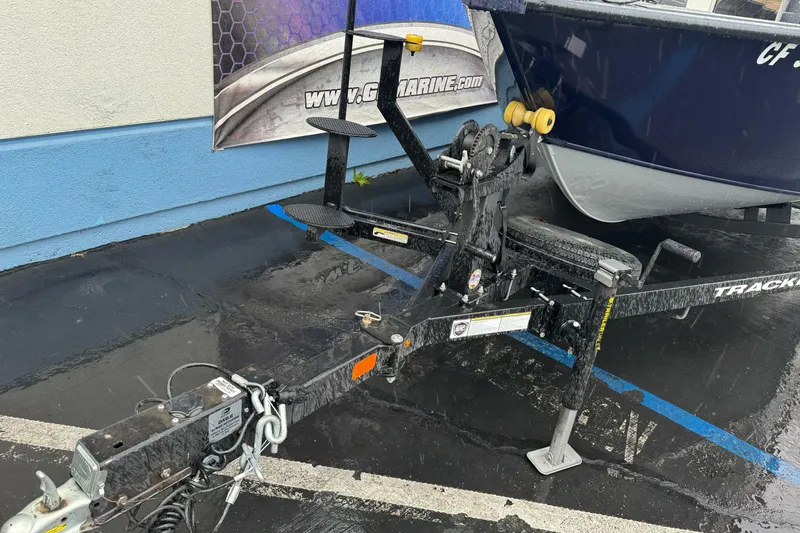Slide: The Image of 2025 Tracker Targa V-19 WT boat trailer in a wet parking lot. - 4