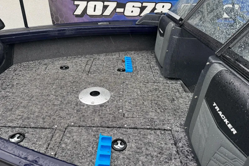 Slide: The Image of 2025 Tracker Targa V-19 WT boat interior with carpeted deck and storage compartments. - 6