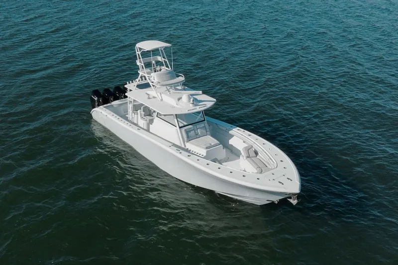 Slide: The Image of 2023 Yellowfin 42 Offshore boat on open water, showcasing sleek design and powerful engines. - 14