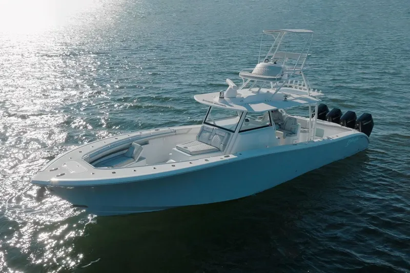 Slide: The Image of 2023 Yellowfin 42 Offshore boat on calm water, showcasing sleek design and powerful engines. - 16
