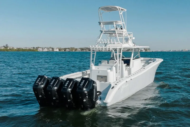 Slide: The Image of 2023 Yellowfin 42 Offshore boat with triple outboard engines on open water. - 18