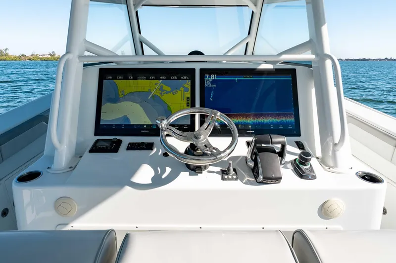 Slide: The Image of 2023 Yellowfin 42 Offshore boat dashboard with navigation screens and steering wheel. - 20