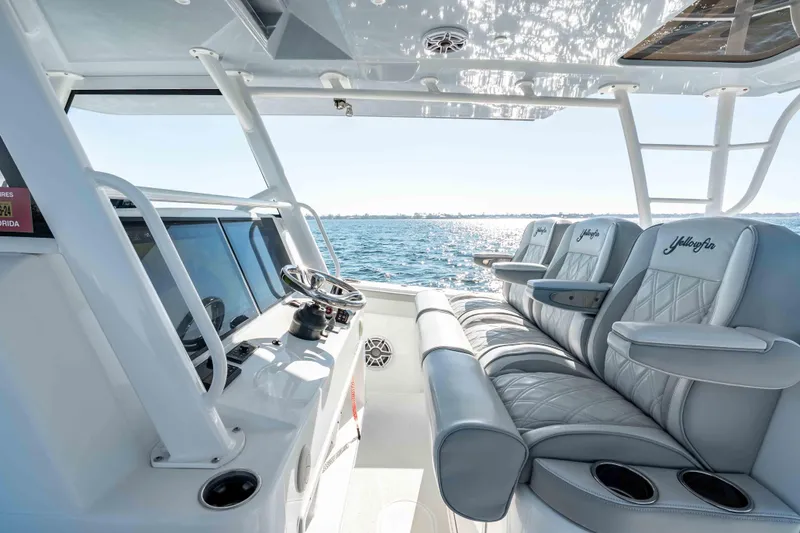 Slide: The Image of 2023 Yellowfin 42 Offshore boat interior with luxurious seating and ocean view. - 22