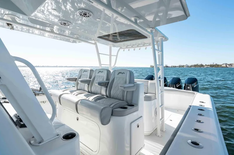 Slide: The Image of 2023 Yellowfin 42 Offshore boat interior with luxurious seating and ocean view. - 23