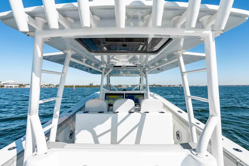 Slide: The Image of 2023 Yellowfin 42 Offshore boat on open water, showcasing sleek design and spacious deck. - 25