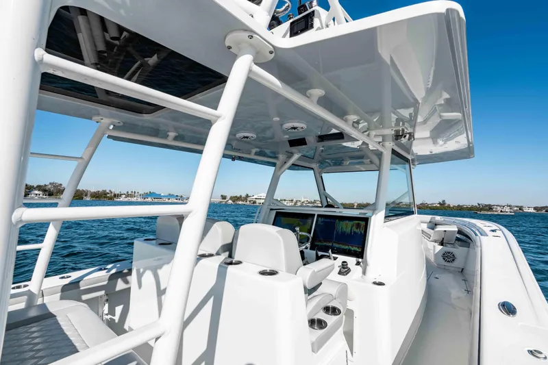 Slide: The Image of 2023 Yellowfin 42 Offshore boat interior with advanced navigation systems on open water. - 26