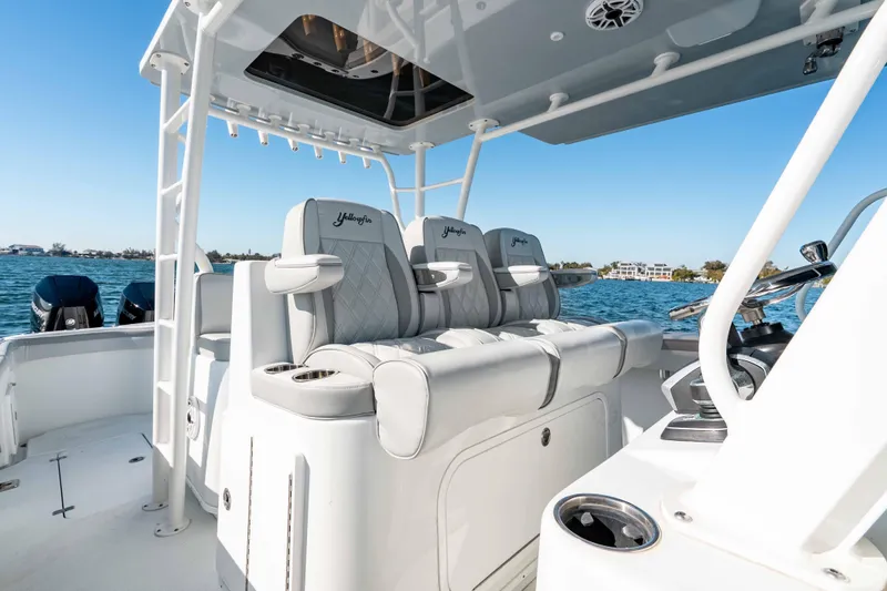 Slide: The Image of 2023 Yellowfin 42 Offshore boat interior with luxury seating on open water. - 27