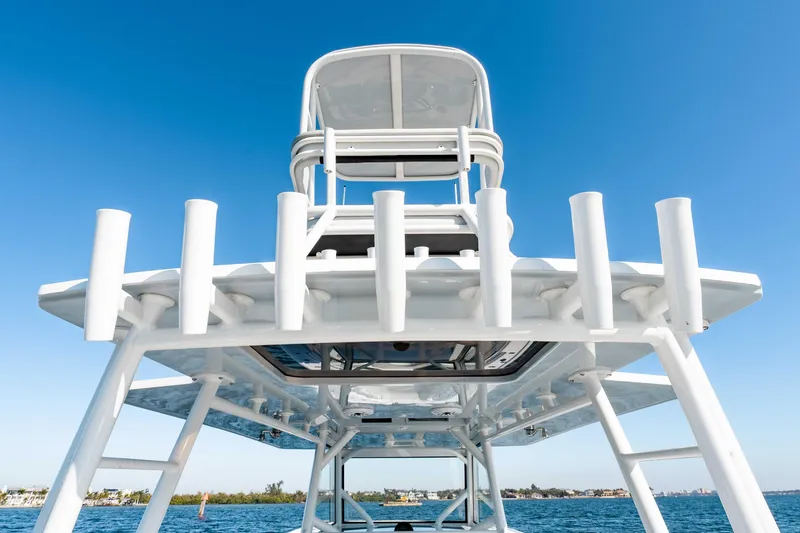 Slide: The Image of 2023 Yellowfin 42 Offshore boat with rod holders, clear blue sky background. - 30