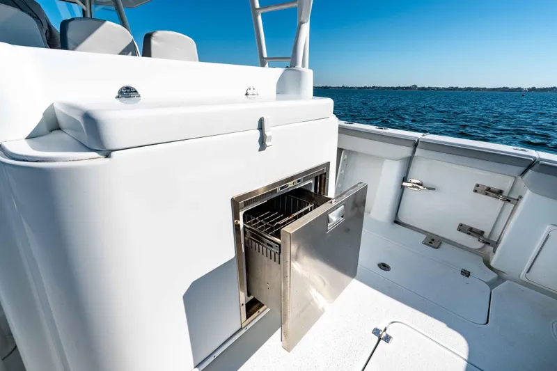 Slide: The Image of 2023 Yellowfin 42 Offshore boat with open storage compartment, ocean view. - 35