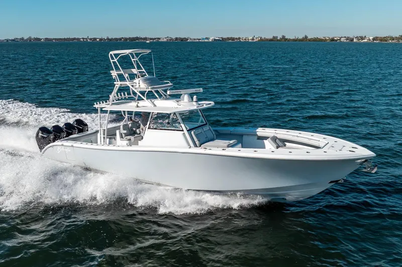 Slide: The Image of 2023 Yellowfin 42 Offshore boat cruising on open water, showcasing sleek design and powerful engines. - 4