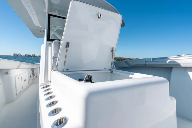 Slide: The Image of 2023 Yellowfin 42 Offshore boat with open storage compartment, sleek design, and ocean backdrop. - 42