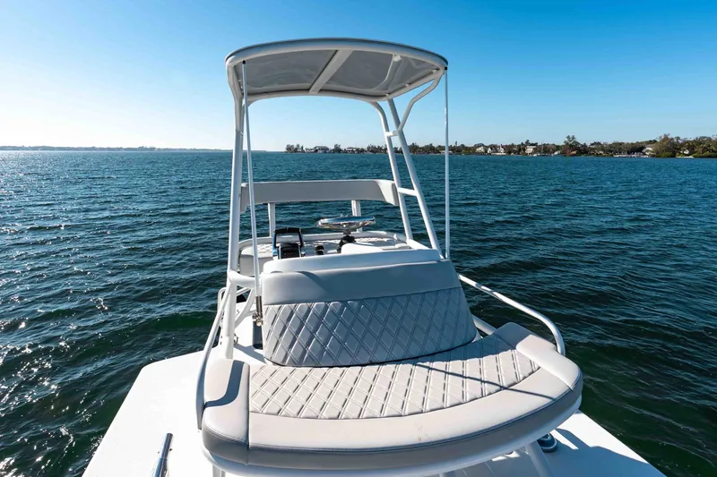 Slide: The Image of 2023 Yellowfin 42 Offshore boat on calm blue water, featuring a sleek design and comfortable seating. - 43