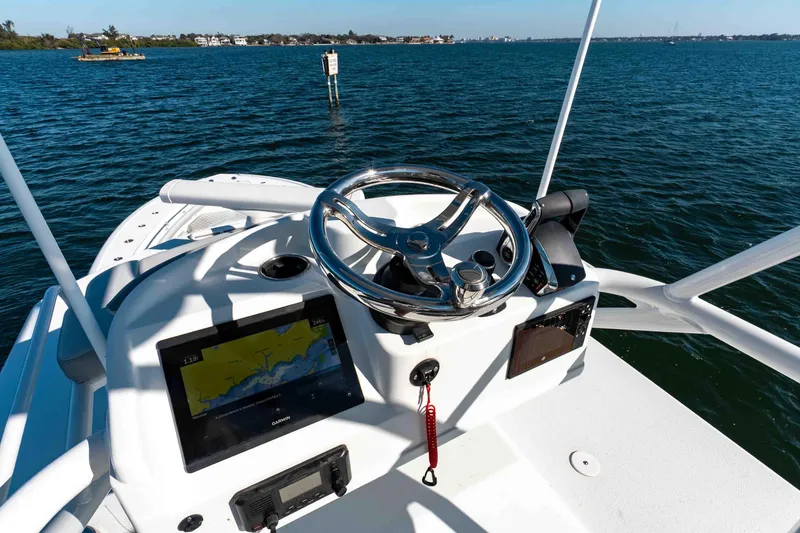 Slide: The Image of 2023 Yellowfin 42 Offshore boat helm with navigation system on open water. - 44