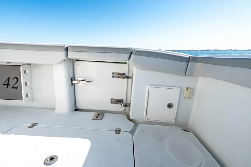 Slide: The Image of 2023 Yellowfin 42 Offshore boat deck with storage compartments and ocean view. - 46