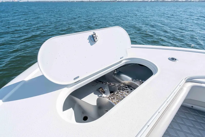 Slide: The Image of 2023 Yellowfin 42 Offshore boat anchor compartment open on calm water. - 55