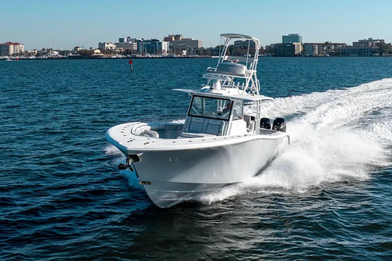 Slide: The Image of 2023 Yellowfin 42 Offshore boat cruising on open water near city skyline. - 6