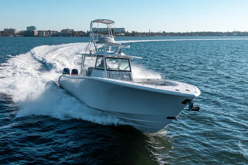 Slide: The Image of 2023 Yellowfin 42 Offshore boat cruising on open water, creating a dynamic wake. - 7