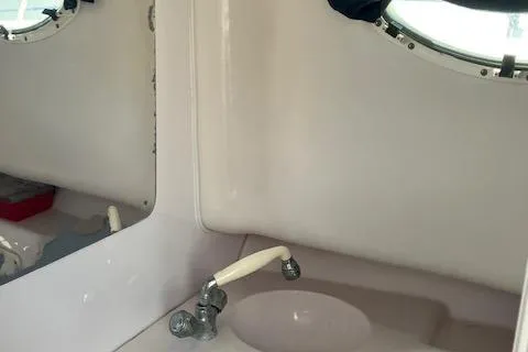 Slide: The Image of 2004 Pro-Line 30 WALK boat interior with sink and porthole window. - 10