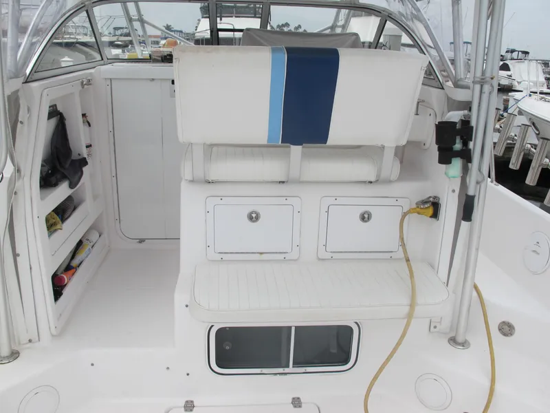 Slide: The Image of 2004 Pro-Line 30 Walkaround boat interior, white seating and storage. - 12