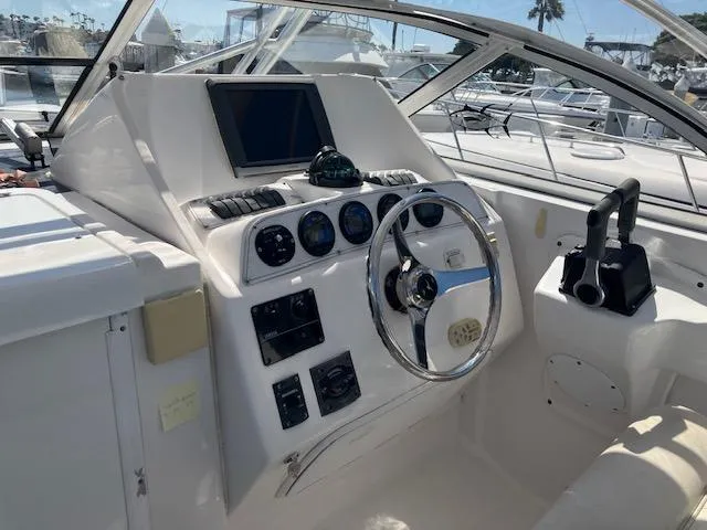 Slide: The Image of 2004 Pro-Line 30 WALK boat cockpit with steering wheel and control panel. - 14