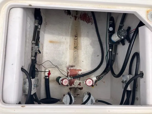 Slide: The Image of 2004 Pro-Line 30 WALK boat compartment with hoses and wiring. - 24