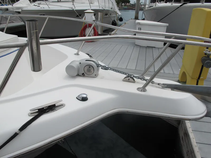 Slide: The Image of 2004 Pro-Line 30 Walkaround boat at dock with anchor windlass. - 28