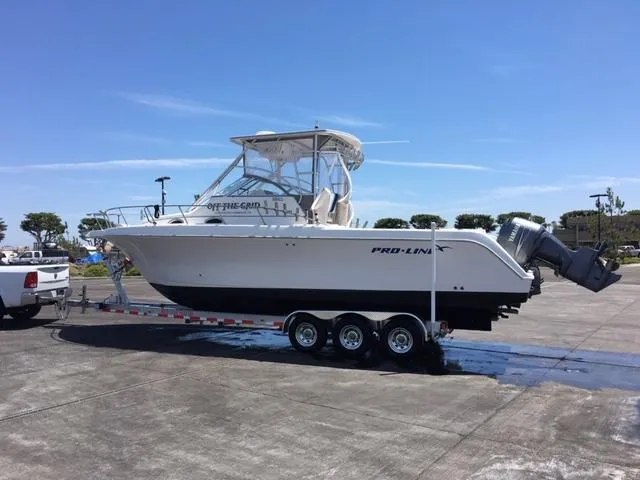 Slide: The Image of 2004 Pro-Line 30 Walkaround boat on trailer. - 31