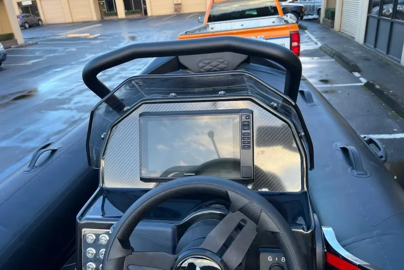 Slide: The Image of 2026 Highfield Sport 420 boat dashboard with steering wheel and navigation display. - 2