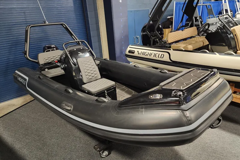 Slide: The Image of 2026 Highfield Sport 420 inflatable boat displayed indoors, featuring sleek design and modern seating. - 8