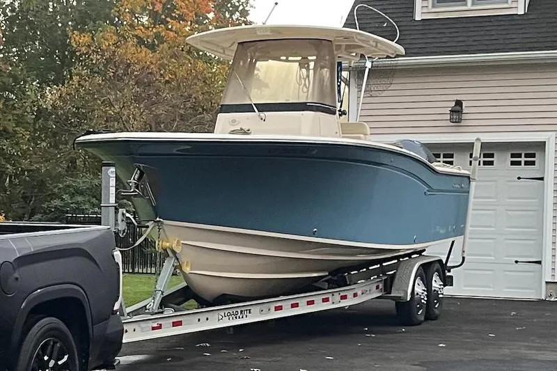 The Image of 2018 Grady-White Canyon 271 boat on trailer in driveway, autumn background. - 0