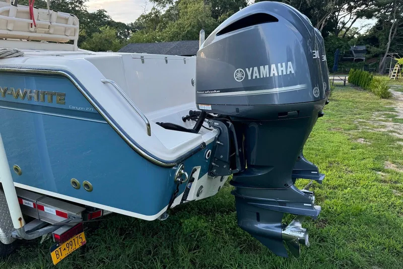 Slide: The Image of 2018 Grady-White Canyon 271 boat with Yamaha outboard motor on grassy area. - 10