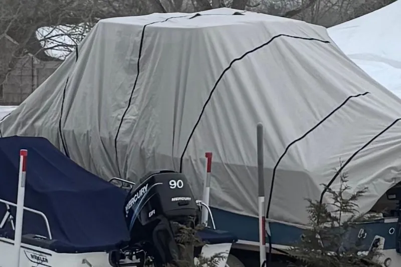 Slide: The Image of 2018 Grady-White Canyon 271 boat covered for winter storage. - 12