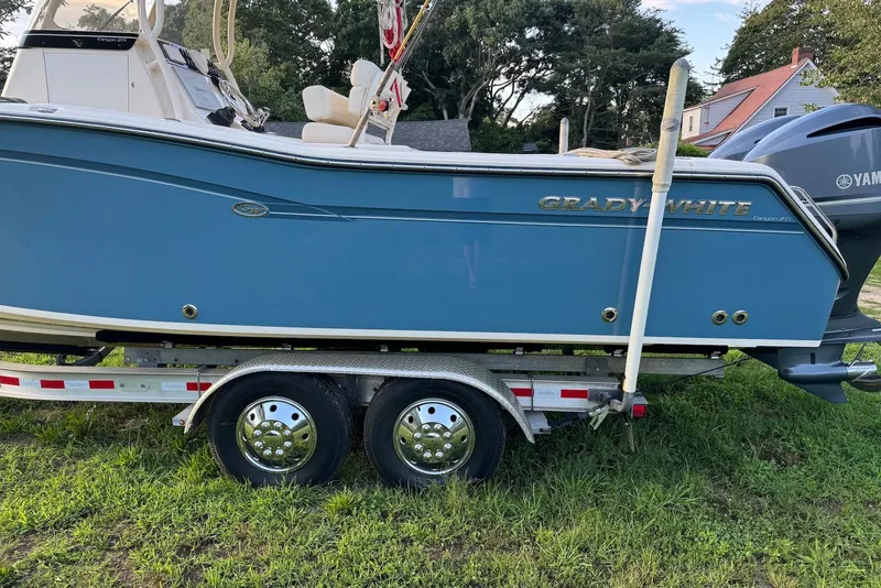 Slide: The Image of 2018 Grady-White Canyon 271 boat on trailer, parked on grass. - 4
