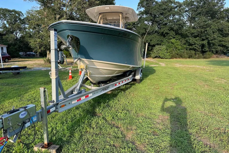 Slide: The Image of 2018 Grady-White Canyon 271 boat on trailer, parked on grassy area. - 5