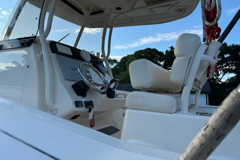 Slide: The Image of 2018 Grady-White Canyon 271 boat interior with steering wheel and seating. - 6