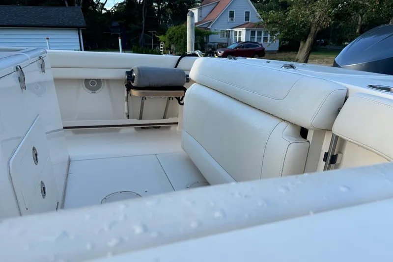 Slide: The Image of 2018 Grady-White Canyon 271 boat interior with white seating and storage compartments. - 7