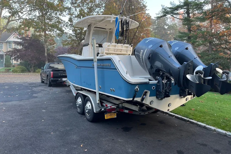 Slide: The Image of 2018 Grady-White Canyon 271 boat on trailer, parked in driveway with trees in background. - 9