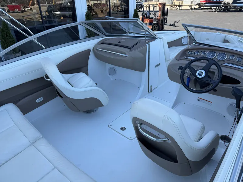 Slide: The Image of Interior of a 2008 Cobalt 202 boat with steering wheel and seats. - 14