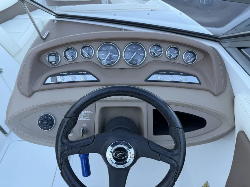 Slide: The Image of Dashboard of a 2008 Cobalt 202 boat with steering wheel and gauges. - 16