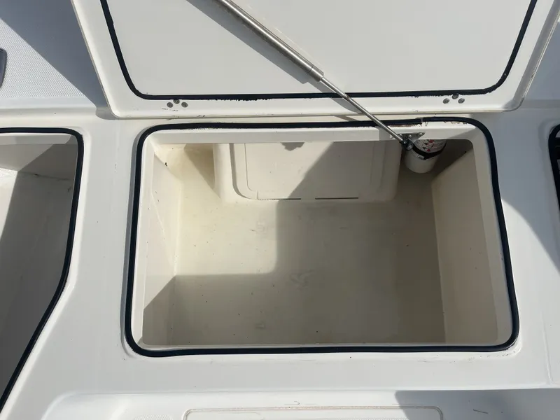 Slide: The Image of Open storage compartment on a 2014 Mako 21 LTS boat. - 15