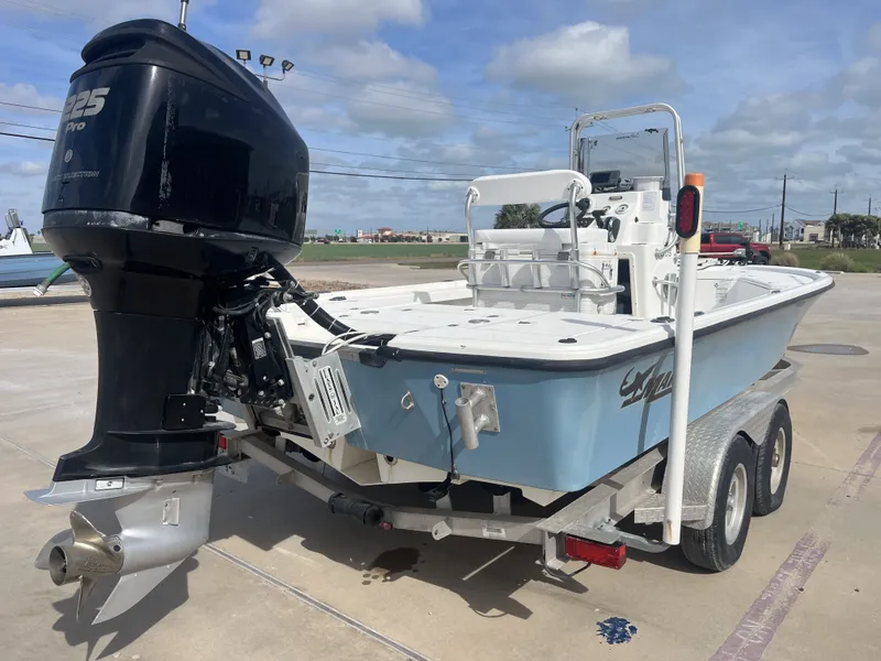Slide: The Image of 2014 Mako 21 LTS boat with outboard motor on trailer. - 8