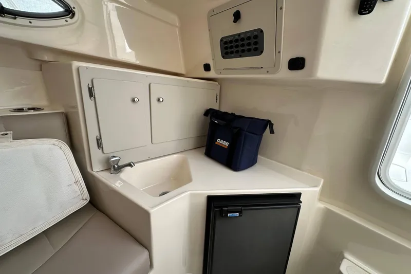 Slide: The Image of 2007 Polar 2300 Walkaround cabin interior with sink, storage, and mini fridge. - 10