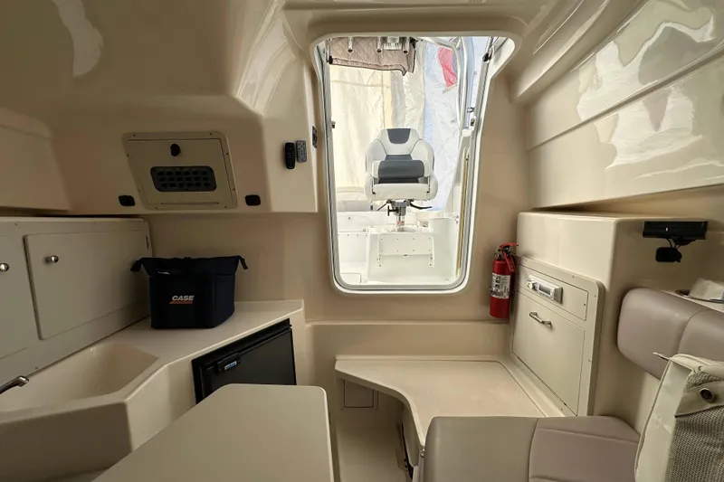 Slide: The Image of Interior of a 2007 Polar 2300 Walkaround boat, featuring seating and storage. - 12