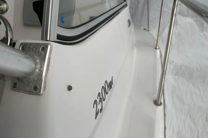 Slide: The Image of 2007 Polar 2300 Walkaround boat, close-up of side railing and model name. - 16