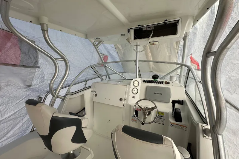 Slide: The Image of 2007 Polar 2300 Walkaround boat interior with steering wheel and navigation equipment. - 17