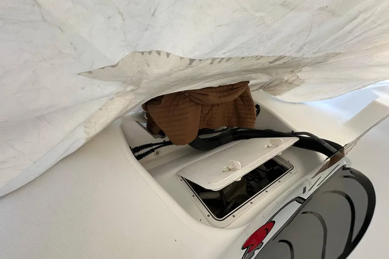 Slide: The Image of 2007 Polar 2300 Walkaround boat interior with open hatch and covered equipment. - 19