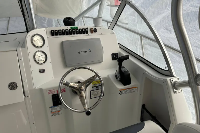 Slide: The Image of 2007 Polar 2300 Walkaround boat dashboard with Garmin navigation system and steering wheel. - 4