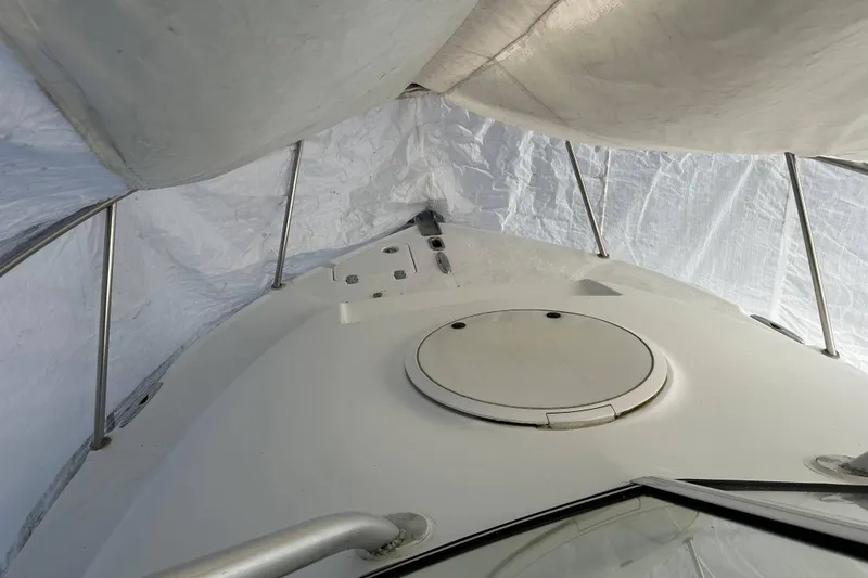 Slide: The Image of 2007 Polar 2300 Walkaround boat under protective cover, showing deck and hatch. - 7